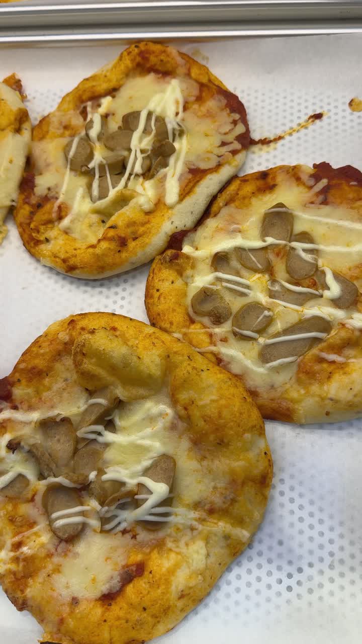 Freshly Baked Mini Pizzas with Sausage and Melted Cheese
