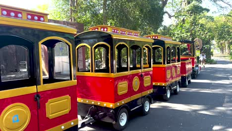 bright tram moving through zoo in chonburi