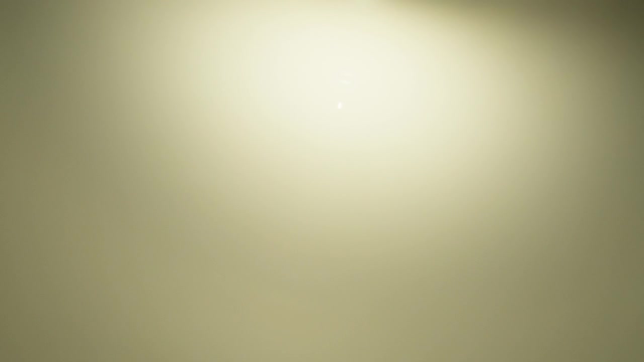 Abstract yellow lens flare appearing on black background