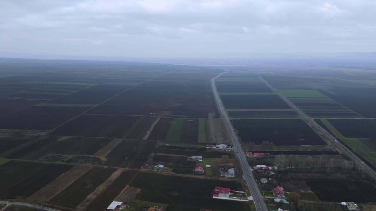 View Of Traffic On Road Between Farmland And Townscape In Vrancea, Romania. - Hyperlapse