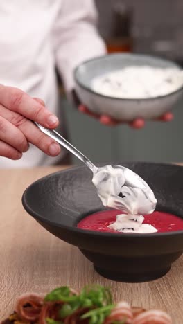 chef preparing a delicious cream-topped soup