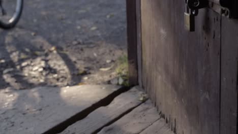 opening wooden rustic door to the outside world