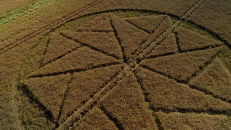 strange farming crop circle pattern artwork stanton st bernard aerial view rising to birdseye wiltshire