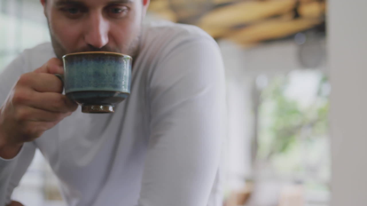 man sipping from ceramic mug in health tech scene, showing animated lightning bolt boosting energy