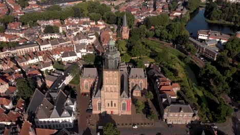 aerial showing walburgiskerk cathedral front exterior facade approaching with drogenapstoren part of city wall entrance of hanseatic town of zutphen, the netherlands, behind