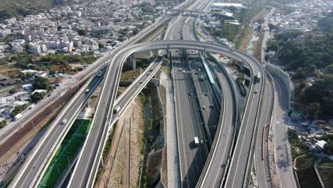 Traffic-on-a-Massive-highway-interchange-with-multiple-levels-and-loop-shaped-road-in-Hong-Kong,-Aerial-view