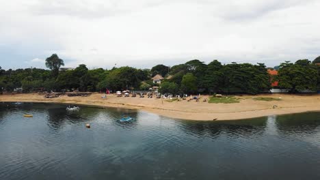 beautiful cinematic sanur beach, bali drone footage with interesting landscape, fishing boats and calm weather