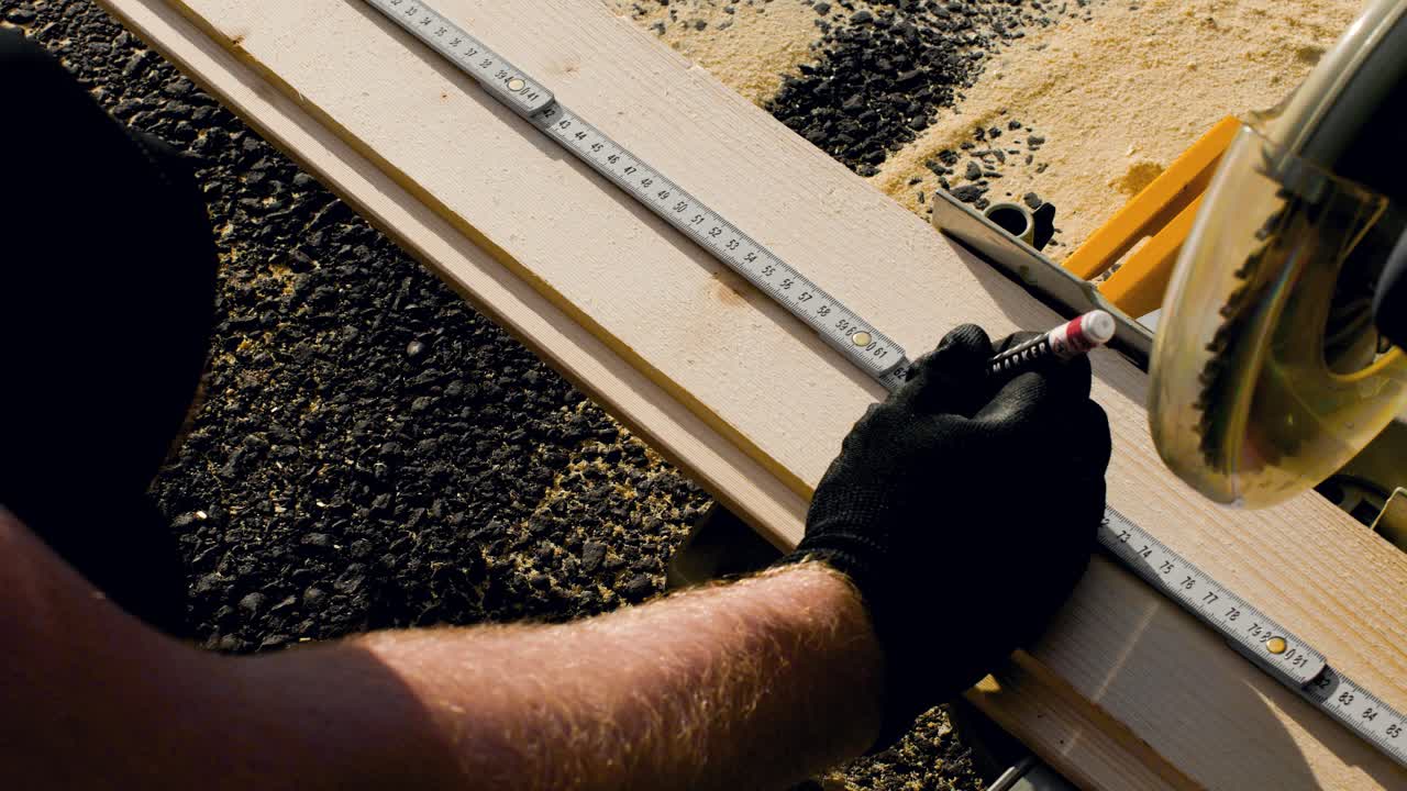 Above View of Carpenter hands Measuring and Marking a Cut Mark with a Thumb Stick on a Piece of Wood in 4K