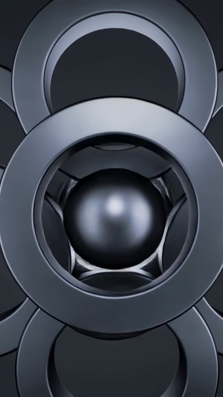 Vertical video: Starting metal rings rotating aligning as shiny sphere settling to nest in studio