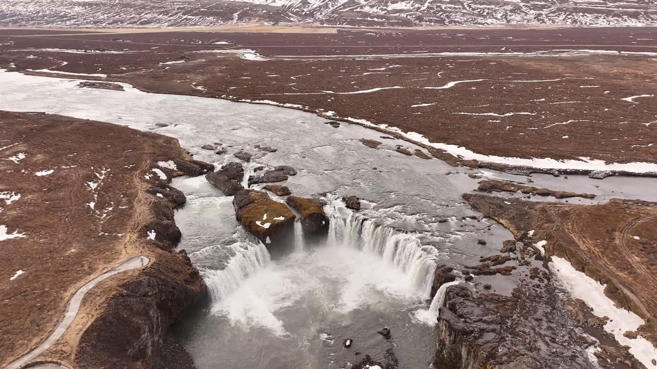 Goðafoss waterfall in Iceland surrounded by snow-covered landscape