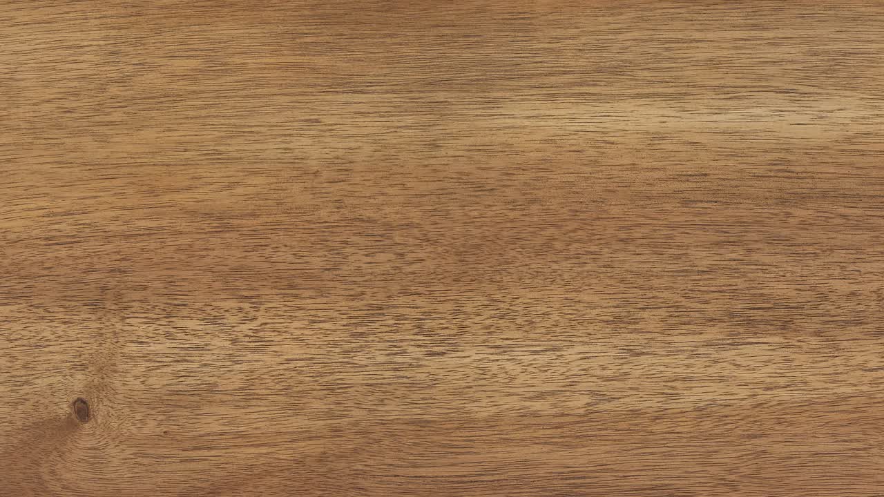 Camera pans across dining tabletop revealing intricate wood grain