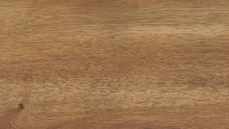 camera pans across dining tabletop revealing intricate wood grain