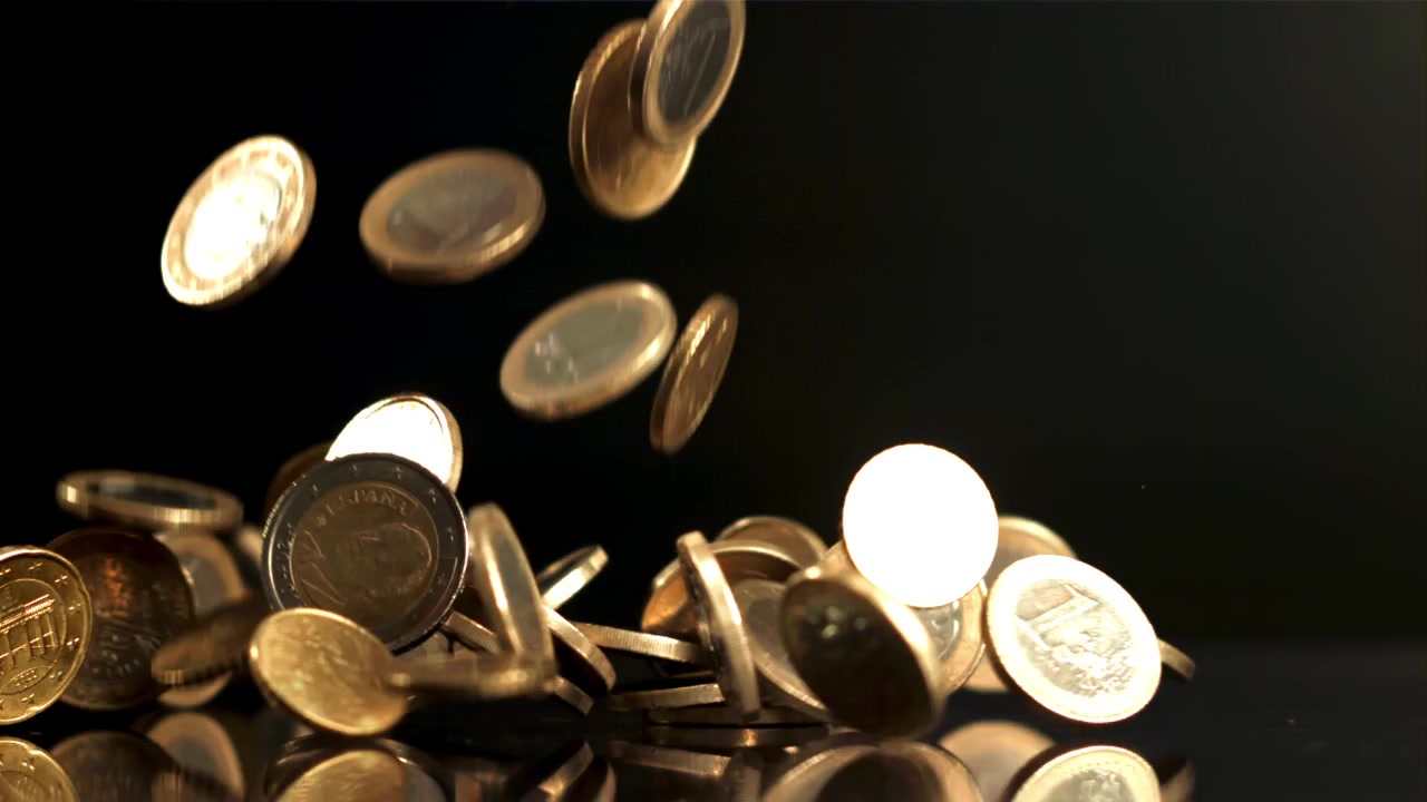 Euro Coins Falling in Slow Motion on Black Reflective Surface
