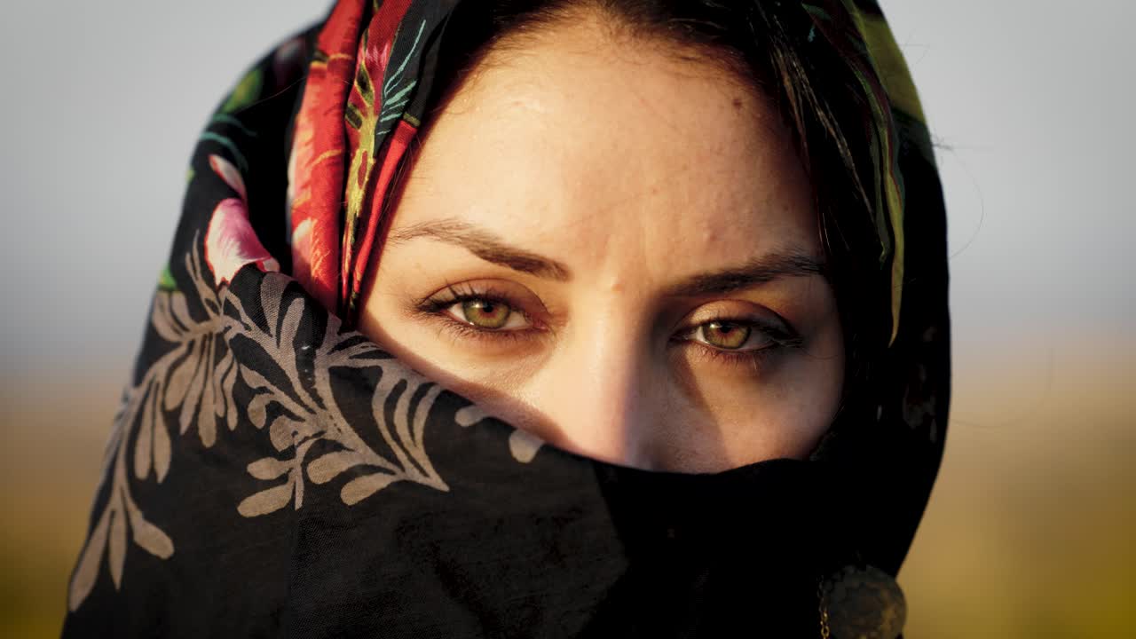 Beautiful muslim woman with hijab looking into camera