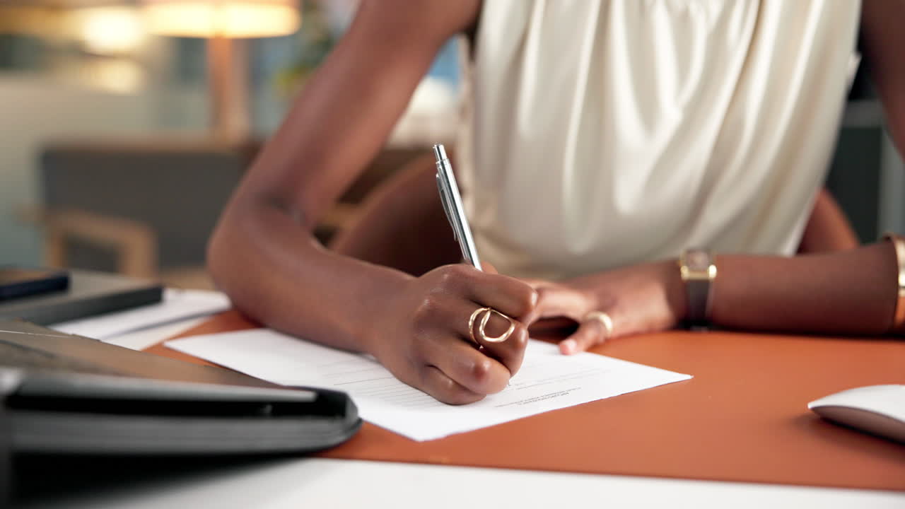 Close-Up of a Person's Hand Writing on a Document