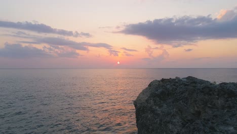 serene sunset over ocean rock formation