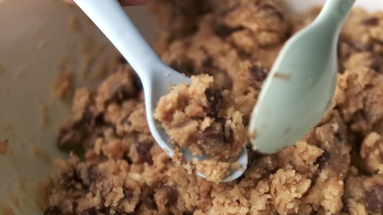 toma de seguimiento de la colocación de masa cruda para galletas con chispas de chocolate en la freidora para cocinar