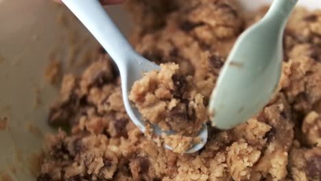 Tracking-shot-of-placing-raw-chocolate-chip-cookie-dough-into-air-fryer-to-cook