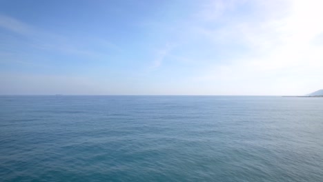 Flying-over-the-Caribbean-Sea-passing-by-a-rocky-breakwater