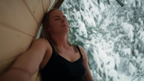 caucasian woman enjoying in the sauna in winter.