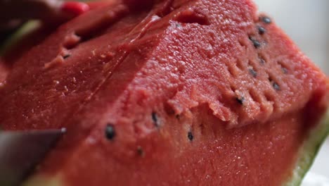 slicing a huge piece of watermelon with a sharp knife filmed in 180 fps slow motion