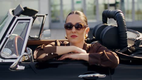 stylish woman driving a vintage convertible
