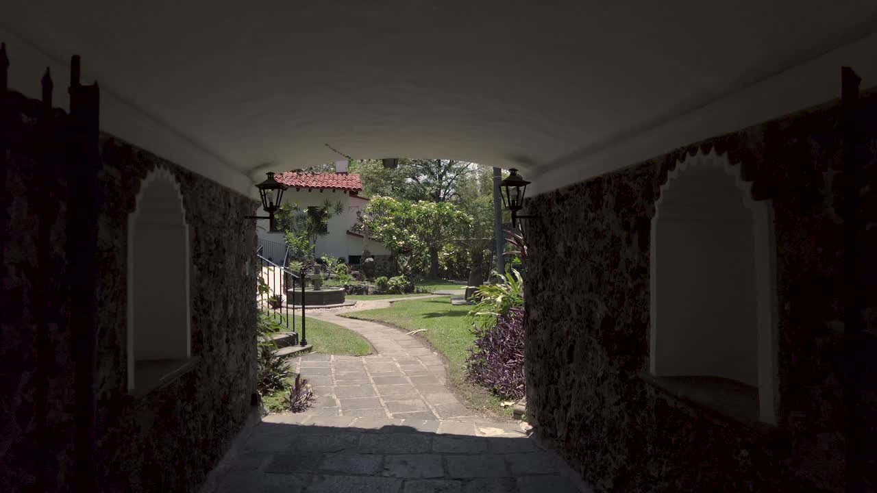 Peaceful Courtyard Garden with Stone Archway and Fountain