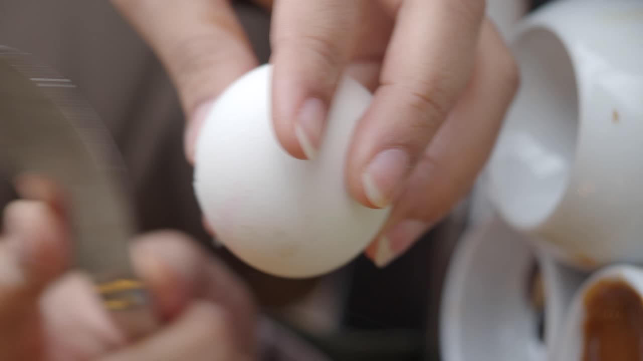 Woman's hands cracking an egg