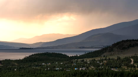 time lapse of the sun setting behind storm clouds looming over lake dillon in colorado's rocky mountains