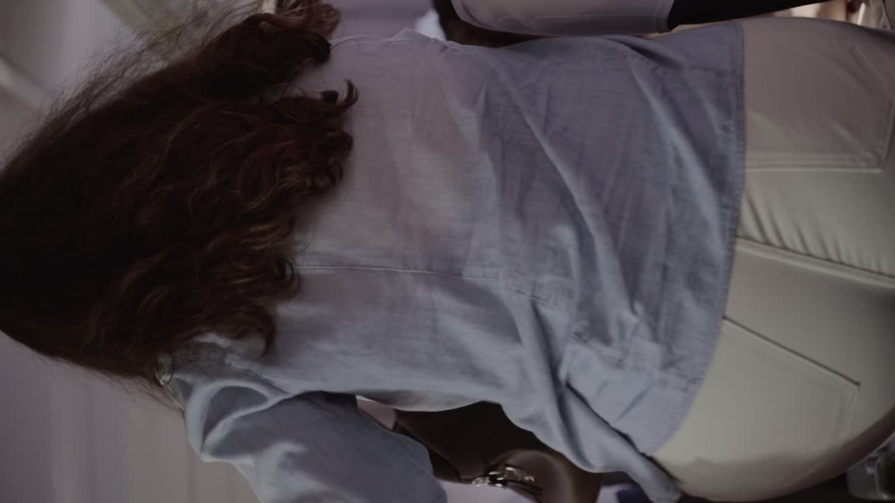 Woman storing bag in overhead compartment on public transport