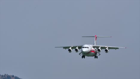 against the smoky skies: a firefighting aircraft prepares to land at kamloops airport