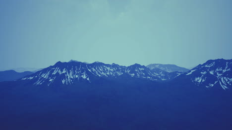 majestic mountain range bathed in soft blue hues during twilight hours