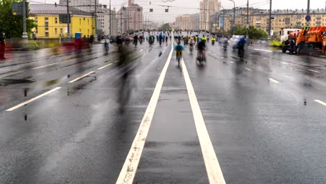 parade of bicyclists, bike riders  despite the bad weather, time lapse