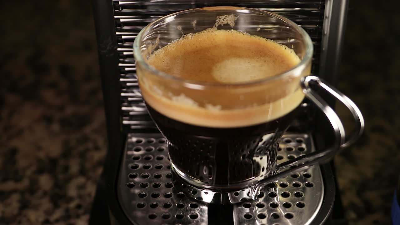 Close up of spot light illuminating filled espresso cup. Static shot