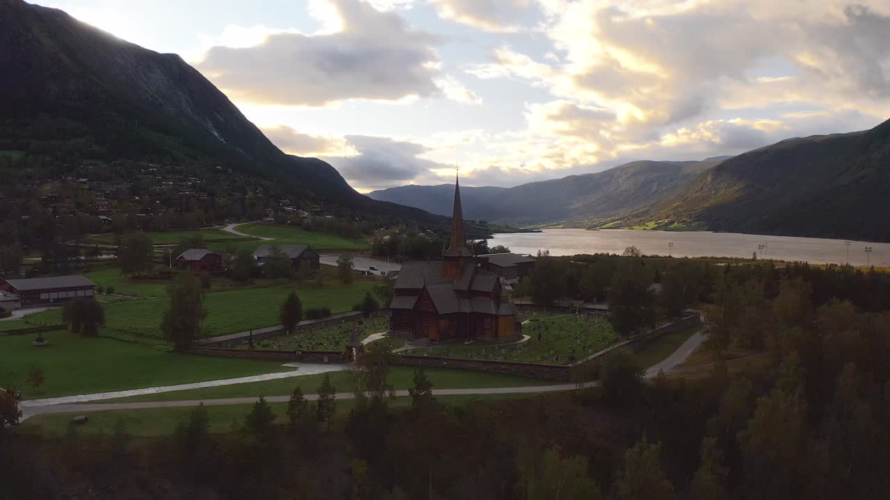A traditional norwegian church, surrounded by mountains and nature, aerial view