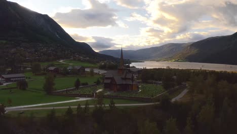a traditional norwegian church, surrounded by mountains and nature, aerial view