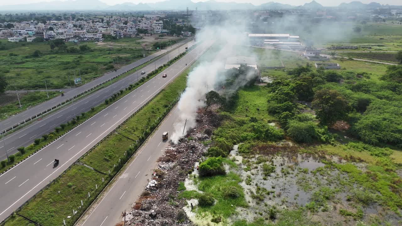 Drone footage of a tranquil highway in Amaravathi, stretching through green farmlands.