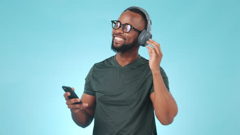 headphones, phone and young black man in a studio