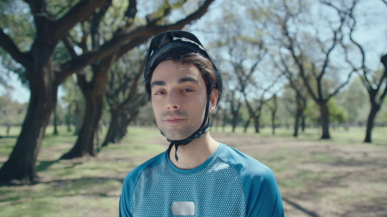 Portrait of Young Cyclist on Alley in the Park
