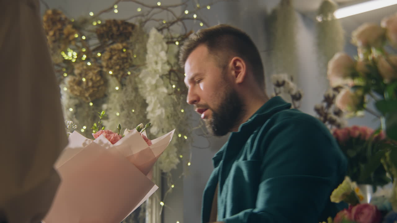 Florist arranging a bouquet of flowers for a customer