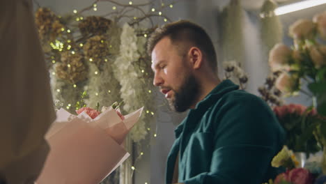 florist arranging a bouquet of flowers for a customer