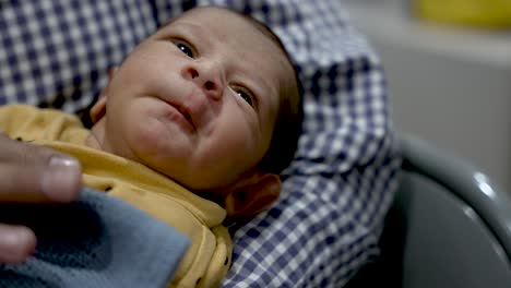 A-tender-moment-captures-a-1-week-old-newborn-boy-cradled-gently-in-the-loving-hands-of-his-parent,-embodying-the-pure-essence-of-the-newborn-concept