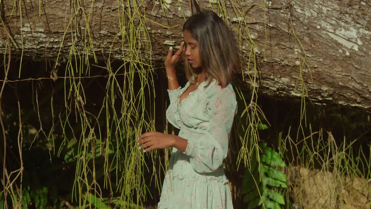 In Trinidad, a young girl with curly hair enjoys a sunny day at a tropical park.