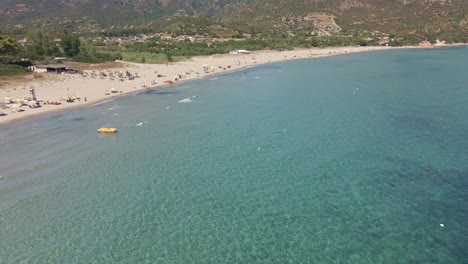 Fly-Drone-View-of-Tropical-Sea-with-People-at-Beach