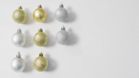 video of christmas baubles and copy space on white background