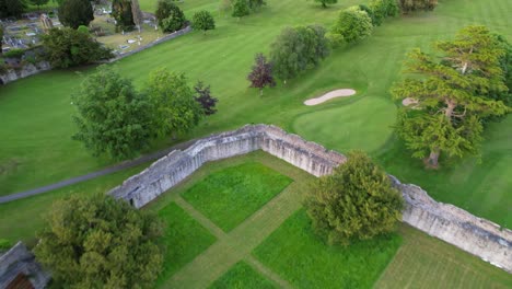 backward drone over desmond castle near maigue river in adare, ireland