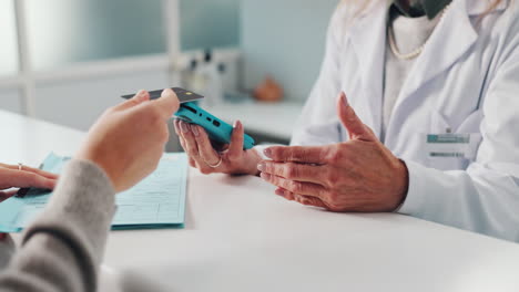 doctor receiving credit card payment from patient