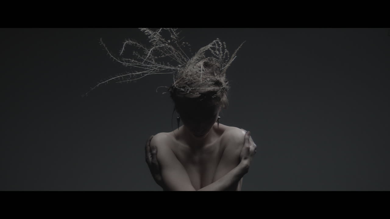 A woman dressed as mother nature rise her head