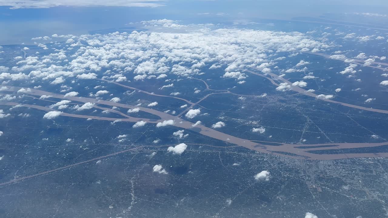 Aerial view of cloudy skies over meandering river system landscape