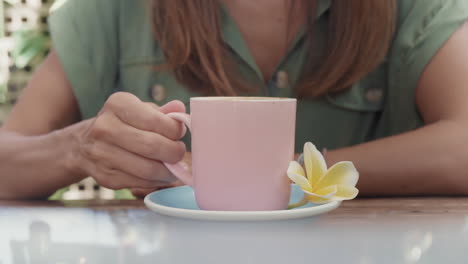 unrecognizable person drinking coffee in mug